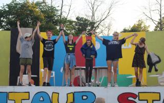 Campers doing a play on the outdoor stage